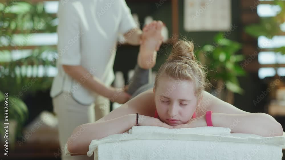 Healthcare time. female massage therapist in massage cabinet with teenage client making massage. Healthcare time. female massage therapist in massage cabinet with teenage client making massage.