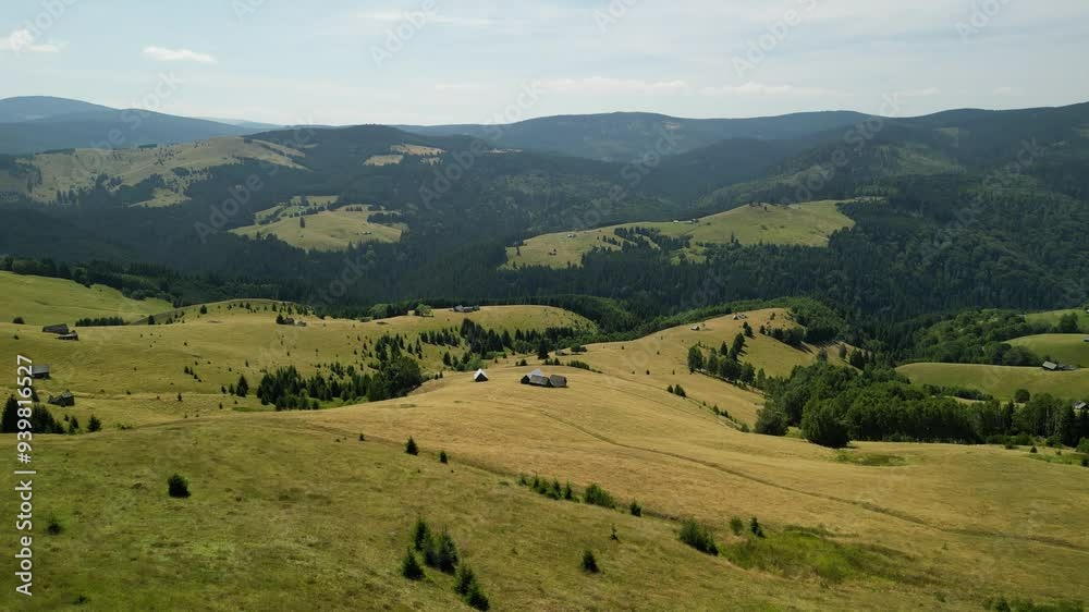 Aerial drone view of the Carpathian mountain village in autumn landscape. A beautiful valley with a village and green meadow with trees. Picturesque nature in Transylvania, Romania. Aerial drone view of the Carpathian mountain village in autumn landscape. A beautiful valley with a village and green meadow with trees. Picturesque nature in Transylvania, Romania.