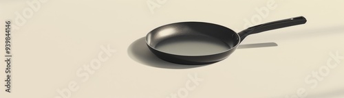 Top View of a Single Black Frying Pan on a Beige Surface, pan, kitchen, cooking, food photo