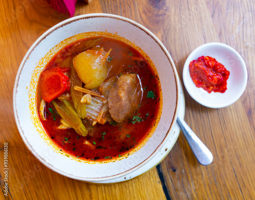 National hearty meat dish of the cuisine of Central Asia Lagman Uygur, which is a thick soup of lamb and vegetables photo