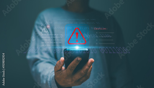 Man using smartphone with red triangle caution warning sign alert for notification error and maintenance, cyber security, Ransomware, Phishing, Spyware, hacker attacks and hacking data.