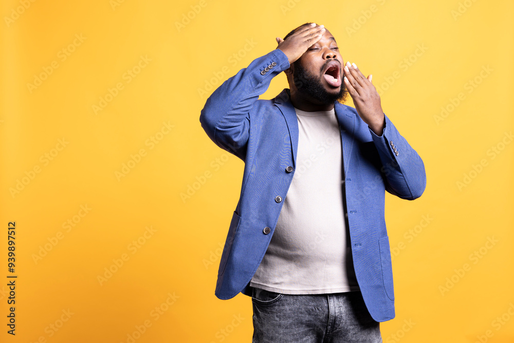 African american man feeling exhausted from overworking, suffering from headache and yawning, isolated over studio background. Tired BIPOC person feeling pain from fatigue African american man feeling exhausted from overworking, suffering from headache and yawning, isolated over studio background. Tired BIPOC person feeling pain from fatigue