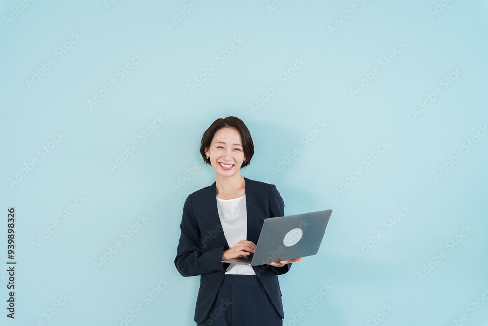 パソコンを使うビジネスウーマン　ブルーバック