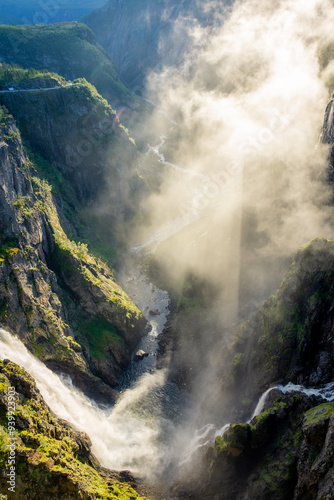 Amazing sunbeams passing through the mist created by the Voringfossen  waterfalls, Norway