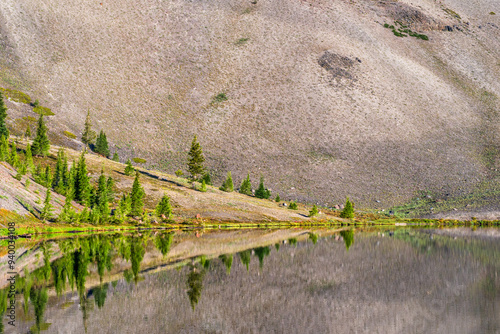 still lake in from of mountain slope