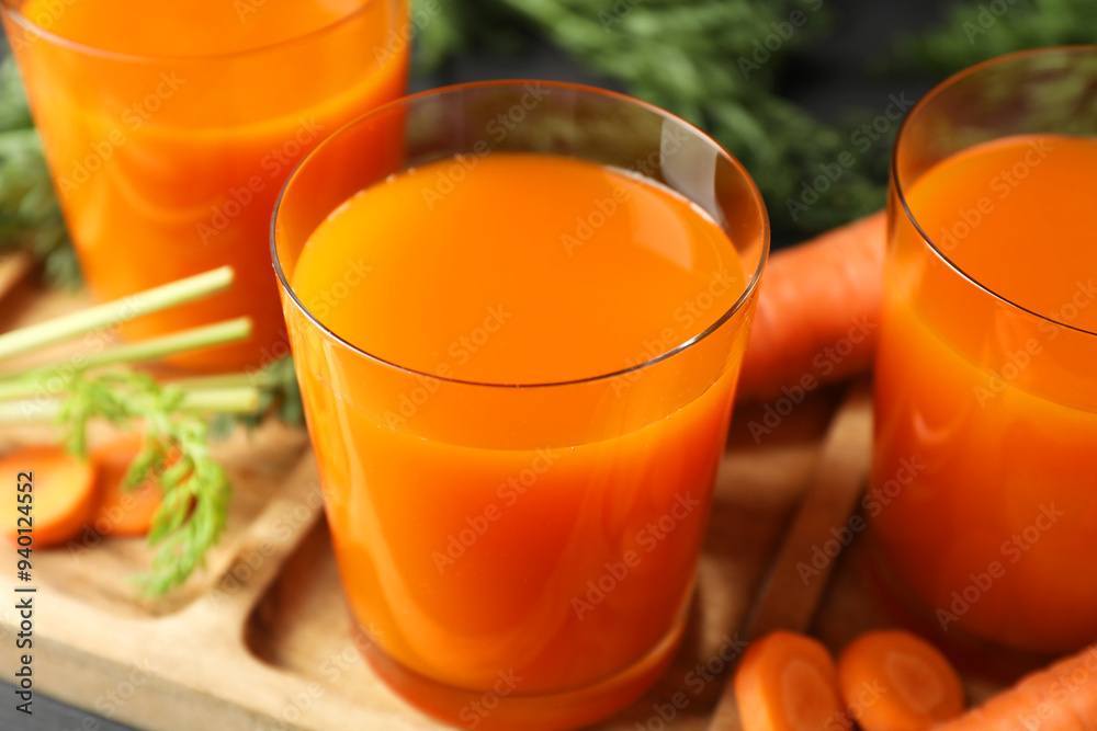 Healthy carrot juice in glasses and fresh vegetable on table, closeup Healthy carrot juice in glasses and fresh vegetable on table, closeup