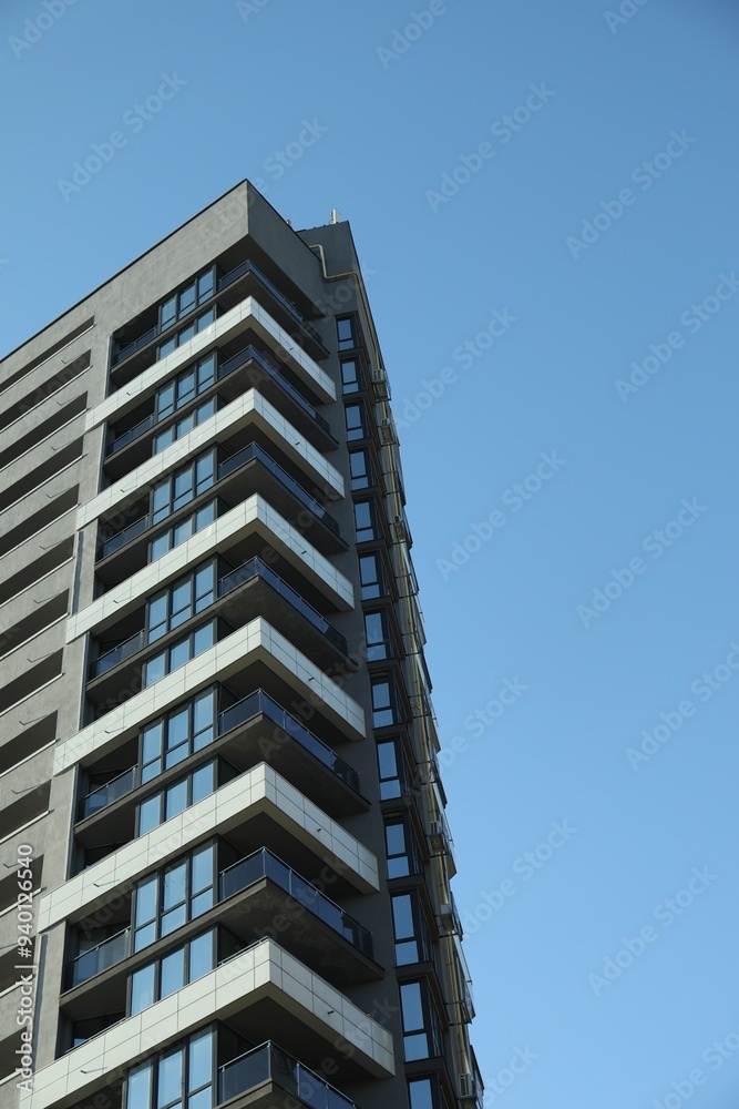 Exterior of modern building against blue sky, low angle view Exterior of modern building against blue sky, low angle view