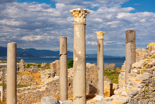 Remains of stone walls and Corinthian columns topped with decorative ornate capitals of antique central church in Turkish city photo