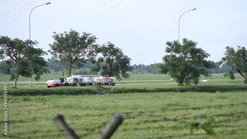 Baggage Towing Tractor is running in the Kualanamu international airport area, Deli Serdang, Sumatera, Indonesia. photo