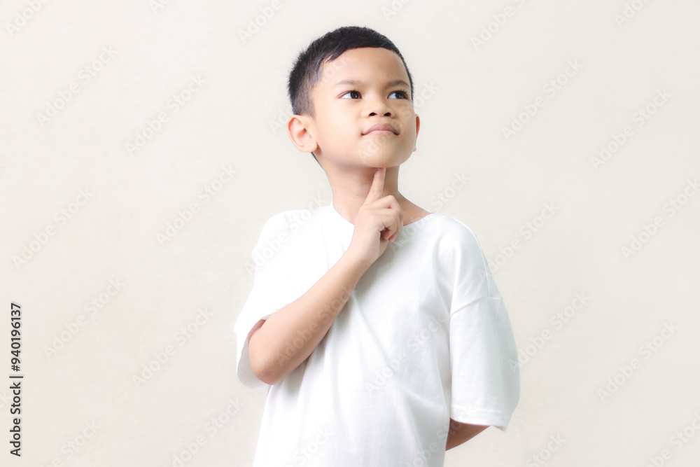 Thinking a cute little asian boy on white background. Child thinking. Education concept. Brainstorming and idea concept. Thinking a cute little asian boy on white background. Child thinking. Education concept. Brainstorming and idea concept.