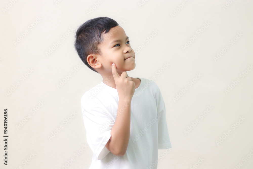 Thinking a cute little asian boy on white background. Child thinking. Education concept. Brainstorming and idea concept. Thinking a cute little asian boy on white background. Child thinking. Education concept. Brainstorming and idea concept.