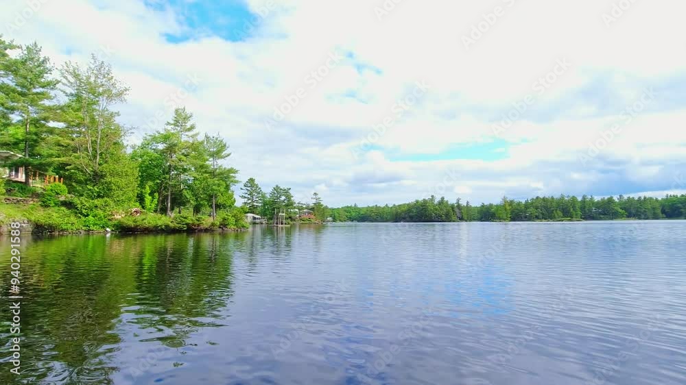 POV from the small boat boating through freshwater lake between spruce fir trees islands and vegetation. View for the boat front trolling moving during fishing. Beautiful North American dream view. POV from the small boat boating through freshwater lake between spruce fir trees islands and vegetation. View for the boat front trolling moving during fishing. Beautiful North American dream view.