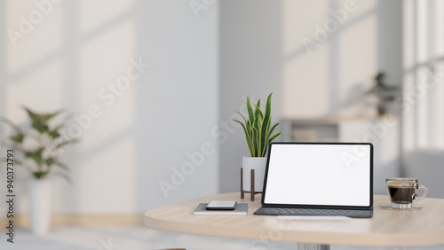 A digital tablet mockup and a wireless keyboard on a wooden table in a minimalist white room.