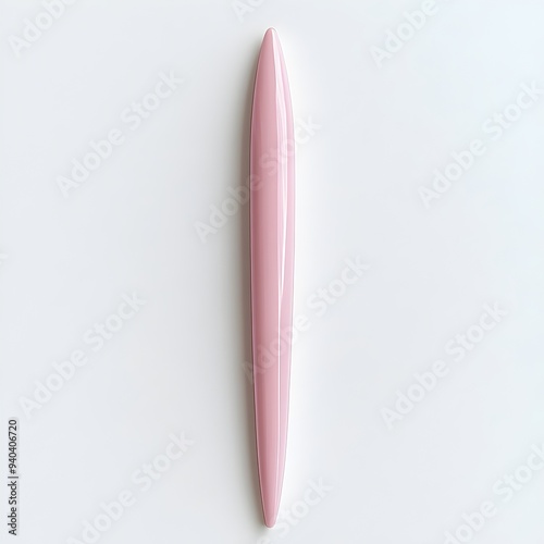 A delicate and feminine pink letter opener placed at the center of a white surface showcasing its sharp pointed design and sleek elegant appearance