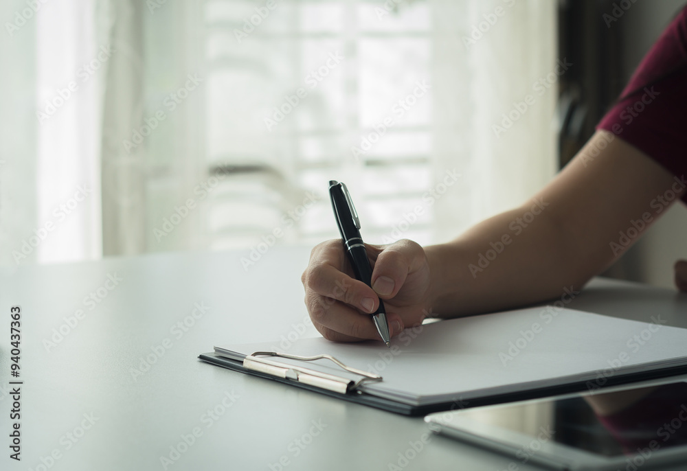 Person working writing in notebook with pen at table Business planning, work recording, financial recording, working with documents Person working writing in notebook with pen at table Business planning, work recording, financial recording, working with documents