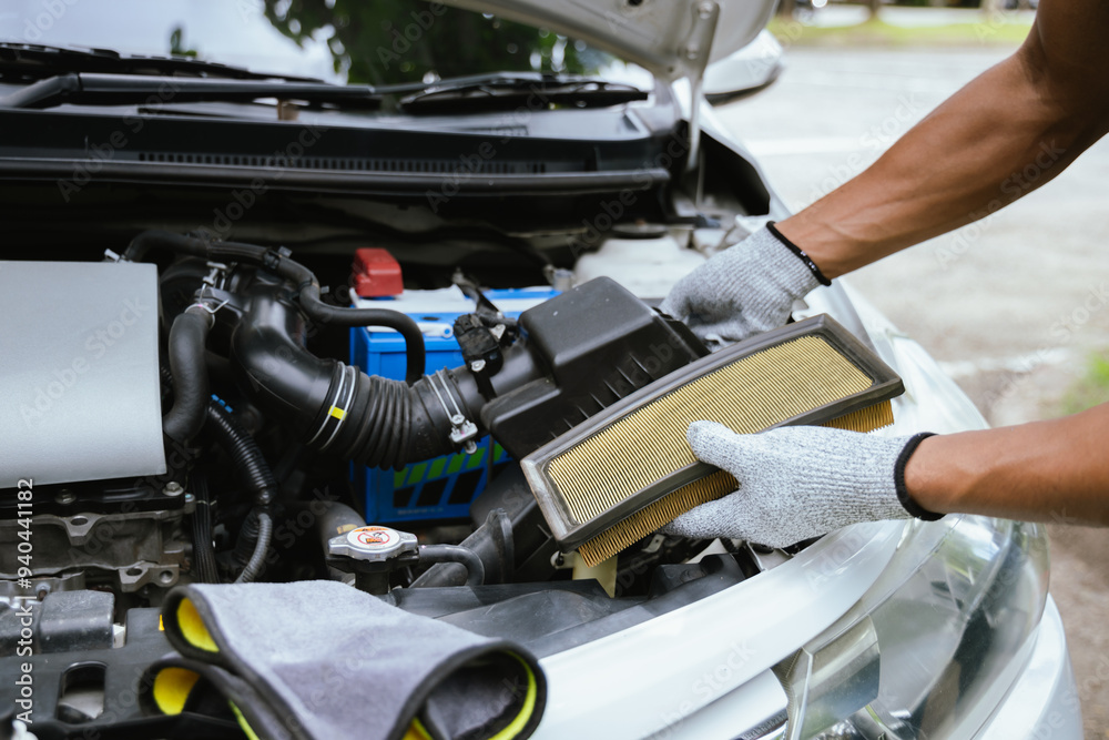 A technician in a workshop uses a wireless device to check a car's condition, updating a digital certificate. The scene highlights automotive repair, service, and efficiency in maintenance. A technician in a workshop uses a wireless device to check a car's condition, updating a digital certificate. The scene highlights automotive repair, service, and efficiency in maintenance.
