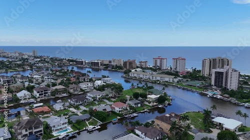 Oceanfront hotel properties and luxury housing in Naples, Florida. Beachfront real estate drone video	