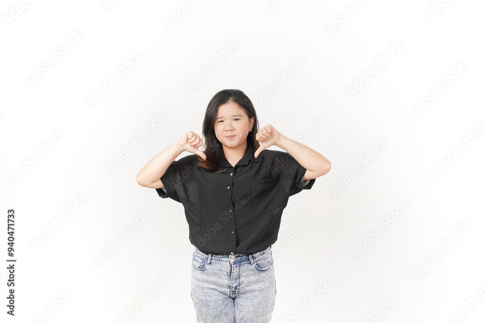 Young Asian woman showing thumbs down wearing Black t-shirt and jeans isolated on white background Young Asian woman showing thumbs down wearing Black t-shirt and jeans isolated on white background