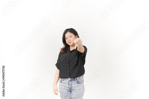 Young Asian woman showing thumbs down wearing Black t-shirt and jeans isolated on white background