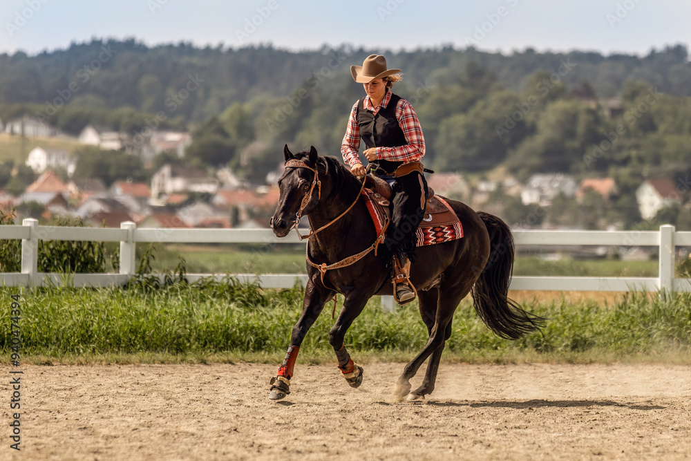 Western riding concept: A young woman and her black quarter horse stallion doing some reining dressage lessons and interacting together Western riding concept: A young woman and her black quarter horse stallion doing some reining dressage lessons and interacting together