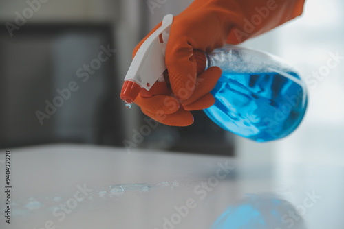Photography Woman cleaning table using rag and diffuser at home.