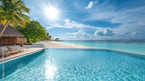 Infinity Pool Overlooking Tropical Beach with Palm Trees and Sunny Skies photo