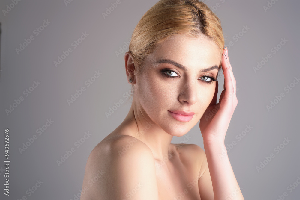 Fashion beauty portrait of young woman with evening stylish makeup and perfect clean skin. Sexy model posing in studio. Portrait of beautiful young girl with bare shoulders. Natural woman. Fashion beauty portrait of young woman with evening stylish makeup and perfect clean skin. Sexy model posing in studio. Portrait of beautiful young girl with bare shoulders. Natural woman.