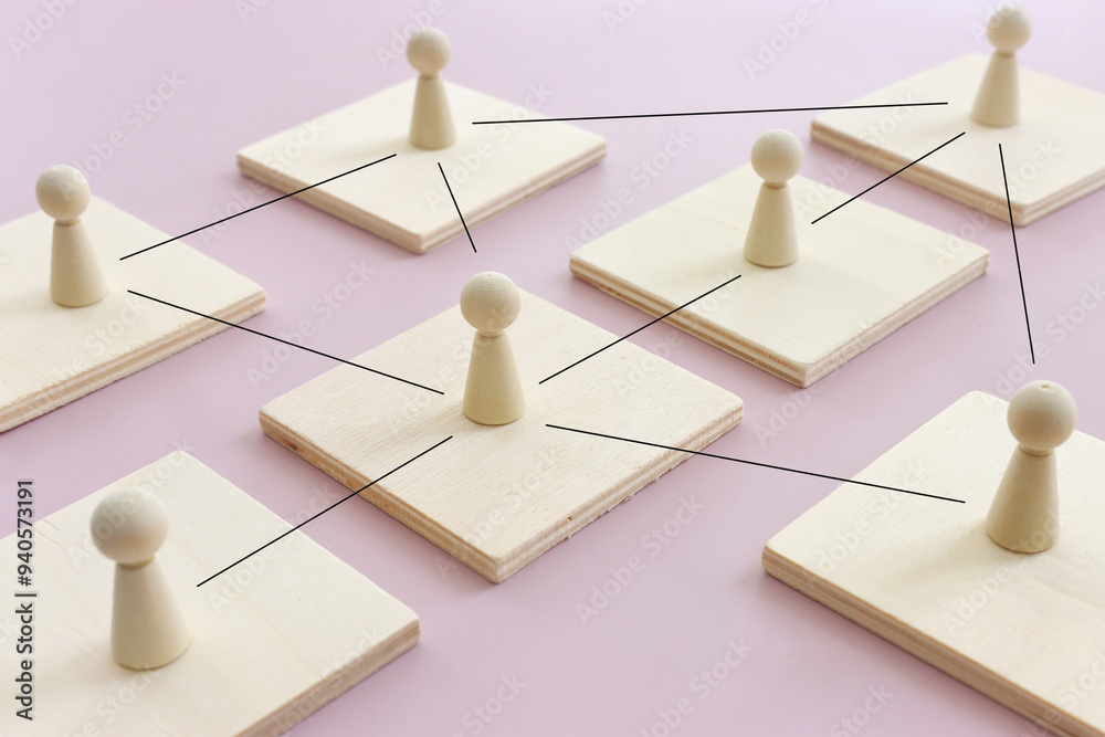 Wooden figures and cubes with connecting lines. Idea of collaboration and teamwork Wooden figures and cubes with connecting lines. Idea of collaboration and teamwork