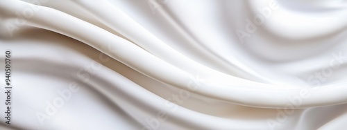  A tight shot of smooth, white fabric displays an intricate center pattern Softness personified