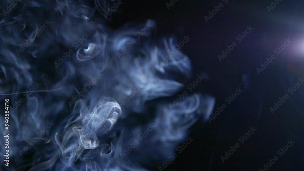 Abstract blue clouds of smoke, fog, steam, mist texture on black in slow motion Abstract blue clouds of smoke, fog, steam, mist texture on black in slow motion