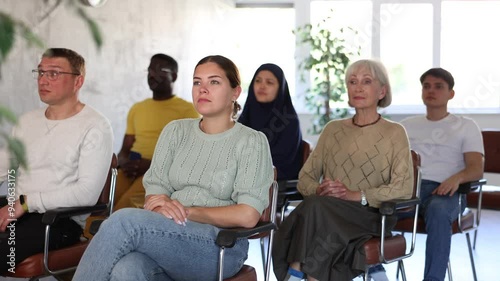 Portrait of students of different years and of different nationalities on training session in lecture hall photo