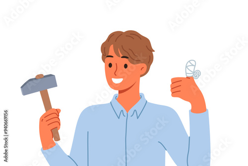 Man injured finger using hammer to drive nail, shows thumbs up and reports that everything is OK. Young guy has finger injury with bandages applied to stop bleeding and avoid infection