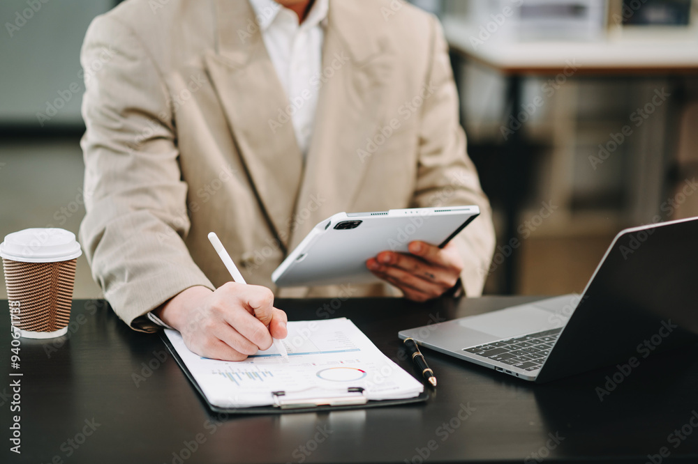 business documents on office table with smart phone and digital tablet and graph financial and woman working business documents on office table with smart phone and digital tablet and graph financial and woman working