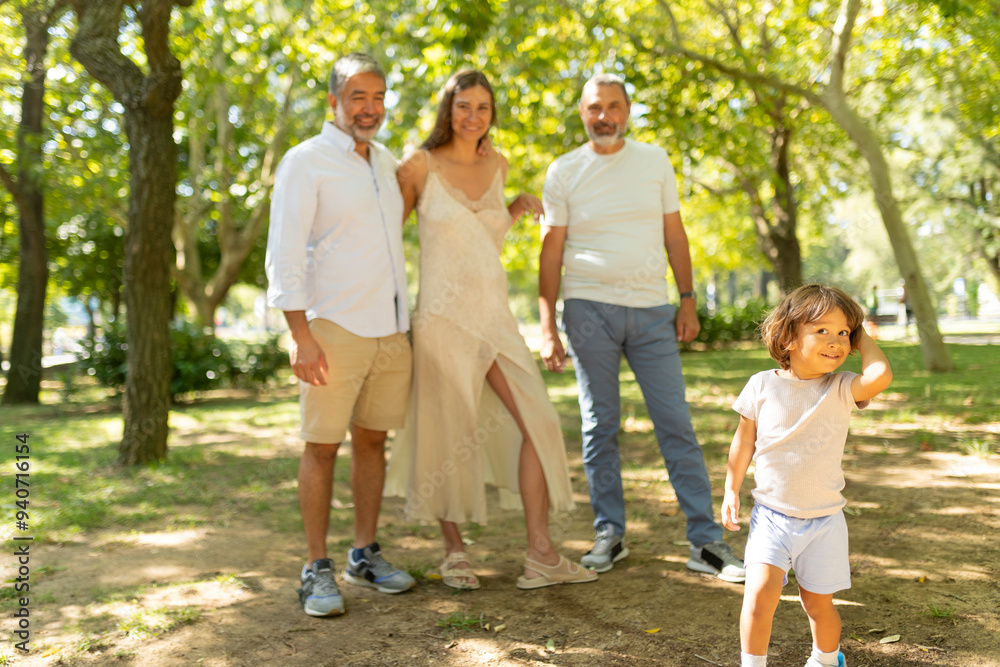 Happy family posing with their grandson in the park Happy family posing with their grandson in the park