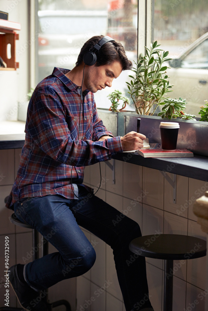 Man, writing and notebook with headphones in coffee shop for remote work, planning or schedule. Person, journalist or writer with book, streaming or music subscription with review for article in cafe Man, writing and notebook with headphones in coffee shop for remote work, planning or schedule. Person, journalist or writer with book, streaming or music subscription with review for article in cafe