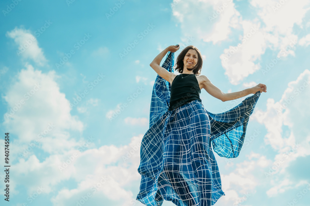 Carefree woman dancing with skirt under cloudy sky Carefree woman dancing with skirt under cloudy sky