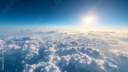 The view from an airplane reveals a breathtaking panorama of clouds and mountains.