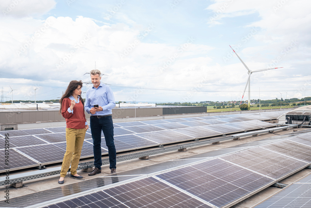 Business colleagues discussing with each other at solar power farm Business colleagues discussing with each other at solar power farm