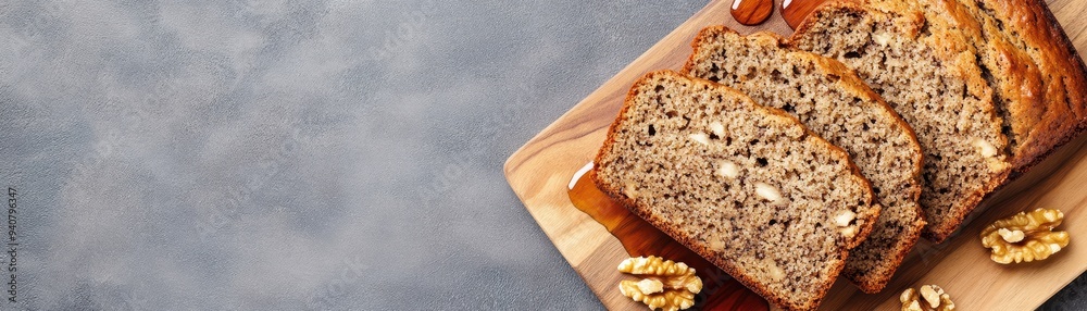 A loaf of bread with walnuts on top of a wooden cutting board A loaf of bread with walnuts on top of a wooden cutting board