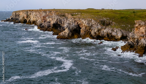 Seascape on the Black Sea, high steep stone coast with inaccessible rocks photo