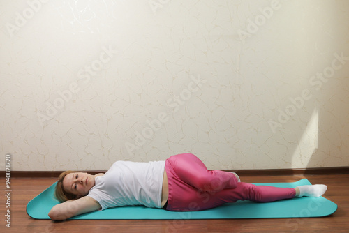 Woman doing yoga at home, enjoying a quiet morning in her room, focusing on stretching and overall wellness.