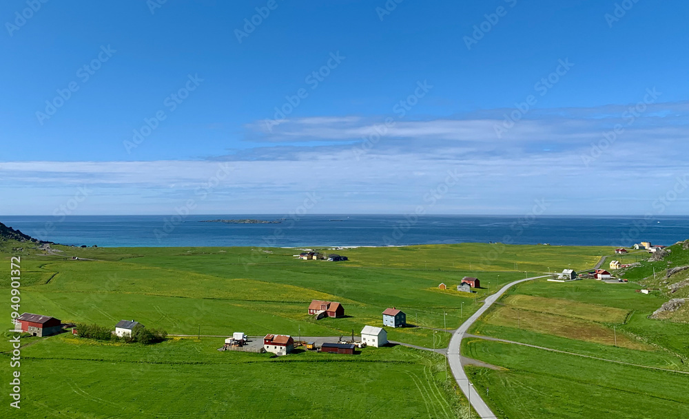 Naklejka premium Aerial view of lush green fields and road to Uttakleiv Beach, Lofoten, Norway