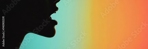 A silhouette of a person speaking against a colorful gradient background. photo