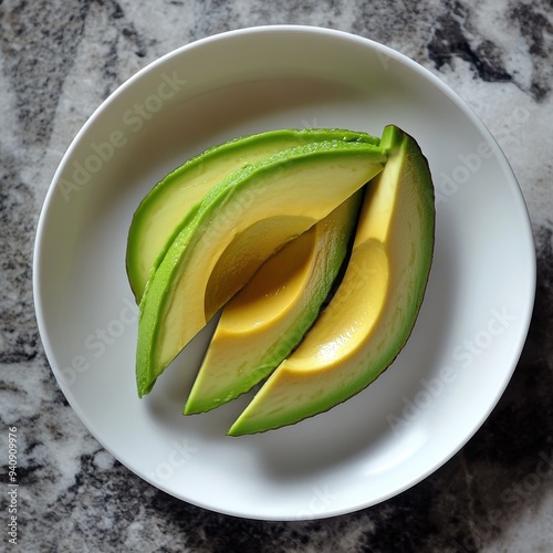 Slice of Alpukat or Avocado (Persea americana), ripe and fresh, served in white plate