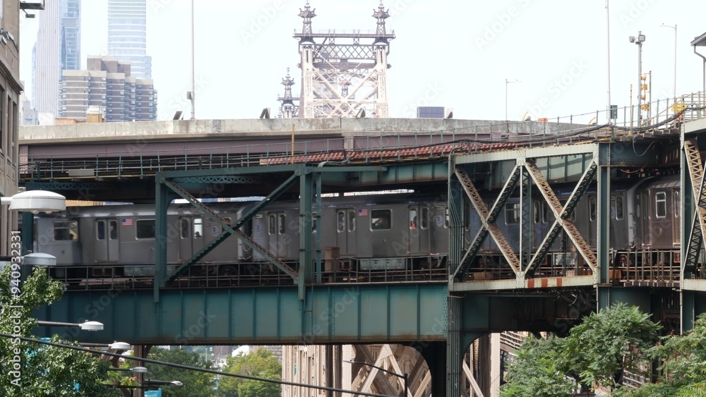 New York elevated subway, metropolitan bridge, metro track above street. Railway transport, vintage Queensboro station railroad line. Queens public train transportation. Long Island city United States New York elevated subway, metropolitan bridge, metro track above street. Railway transport, vintage Queensboro station railroad line. Queens public train transportation. Long Island city United States