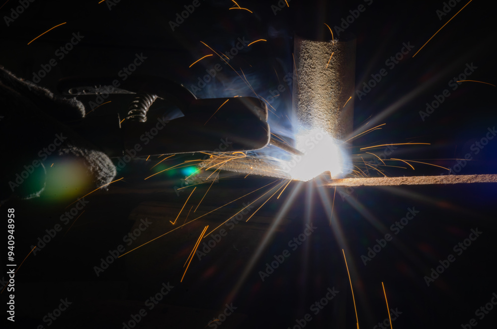 worker welding metal with sparks. worker welding metal with sparks.