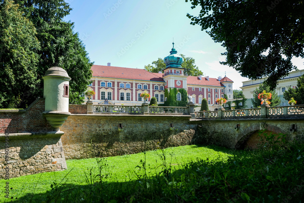 Beautiful castle in Łańcut on a sunny day. Defensive walls in the foreground