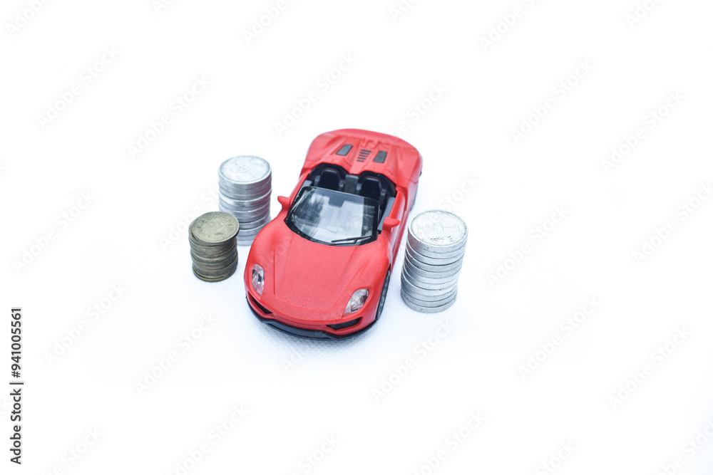 Fototapeta premium Car model on money coins pile. Finance and car loan, saving money for a car, coins insurance, loan and buying car finance concept. buy and installments with white Backgound