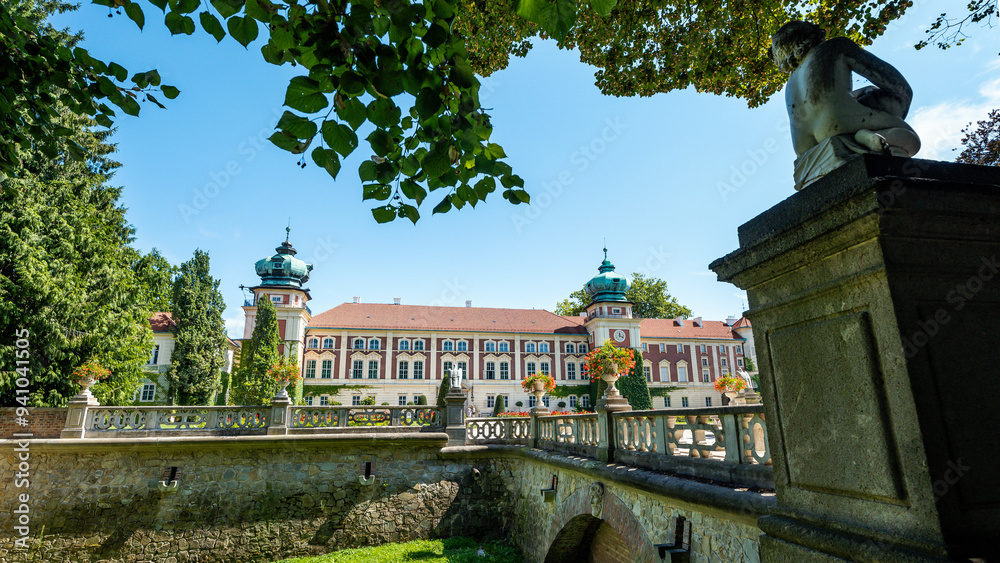 Beautiful castle in Łańcut on a sunny day. Defensive walls, bridge and sculpture in the foreground