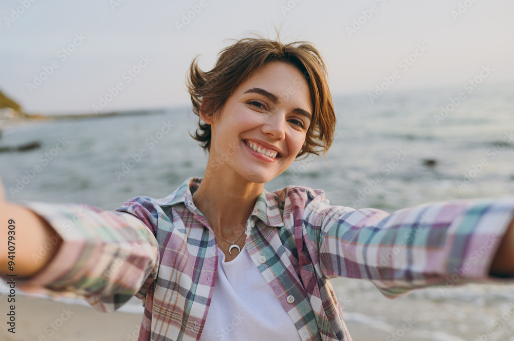 Close up young cheerful fun cool woman wear shirt casual clothes do selfie shot pov on mobile cell phone rest on sea ocean sand shore beach outdoor seaside in summer day free time. Lifestyle concept. Close up young cheerful fun cool woman wear shirt casual clothes do selfie shot pov on mobile cell phone rest on sea ocean sand shore beach outdoor seaside in summer day free time. Lifestyle concept.